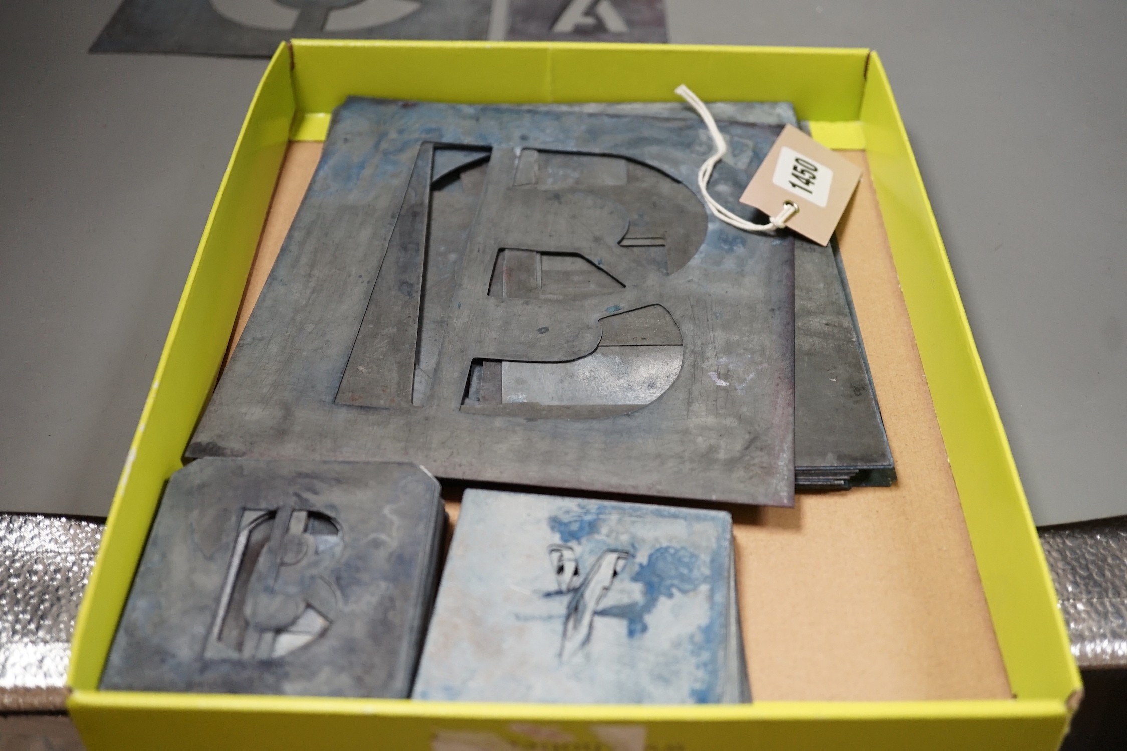 A complete set of zinc alphabet stencils, two incomplete sets of alphabetic stencils and one complete set of numerals